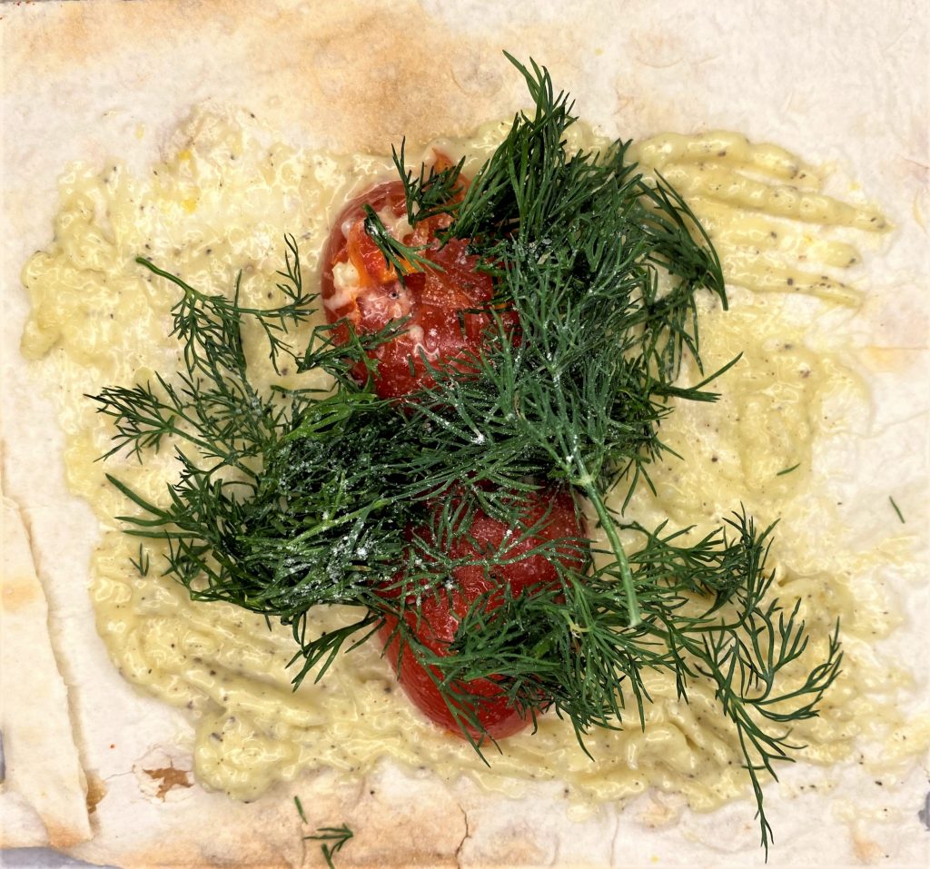 garlic and yogurt with tomato and dill in lavash