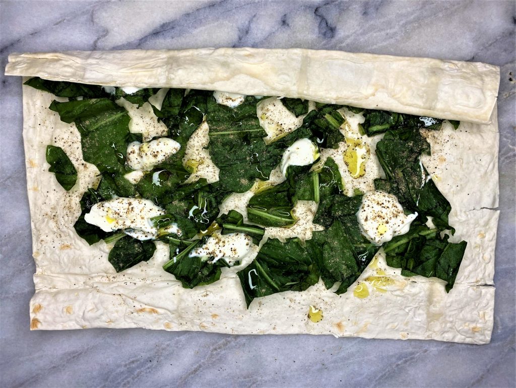 sorrel leaves with olive oil and yogurt on lavash wrap