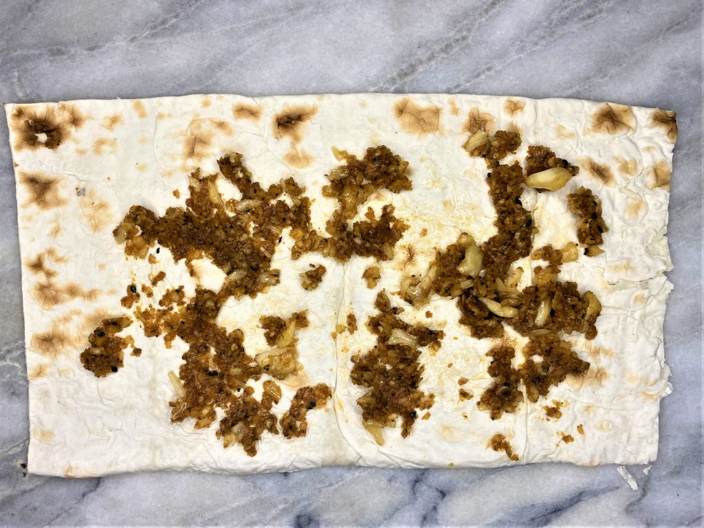 walnut and garlic with spices and salt in a lavash wrap